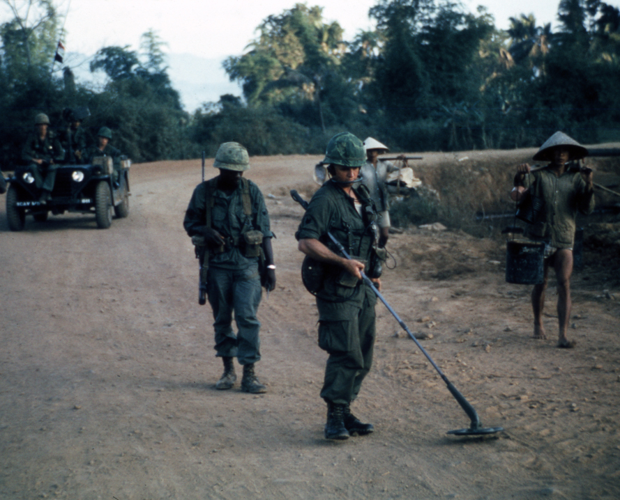 Army engineers sweeping for mines on a road